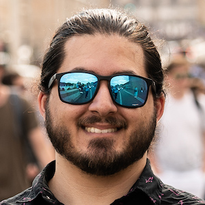 A close up picture of myself wearing sun glasses in Rome, Italy.